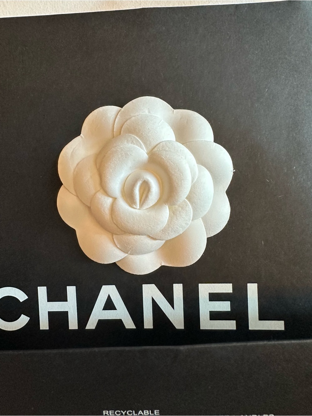 CHANEL White Camellia Hair Accessory and shopping bag